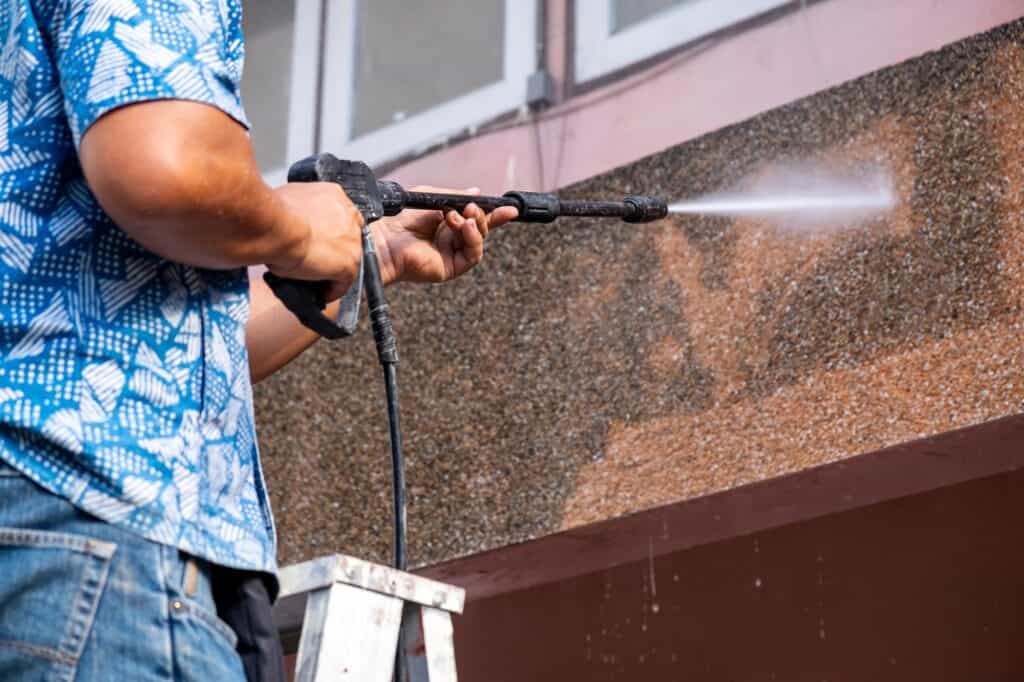 man-pressure-washing-concrete