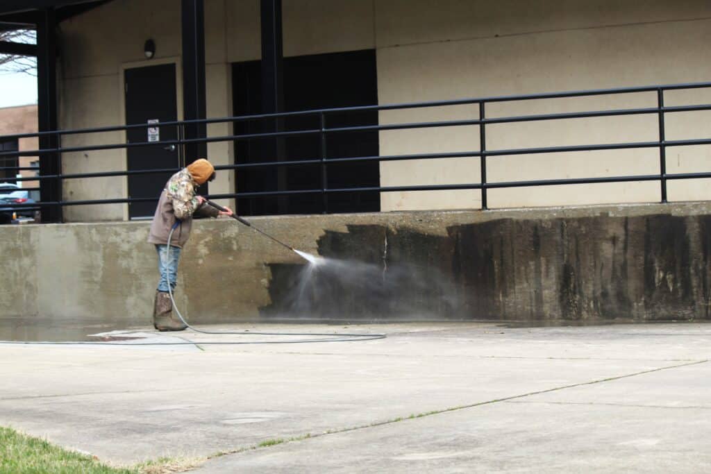 A staff doing parking lot cleaning